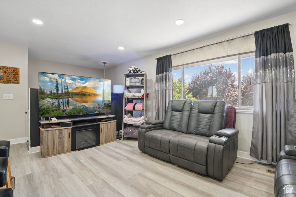 Living room featuring light wood-style floors and recessed lighting