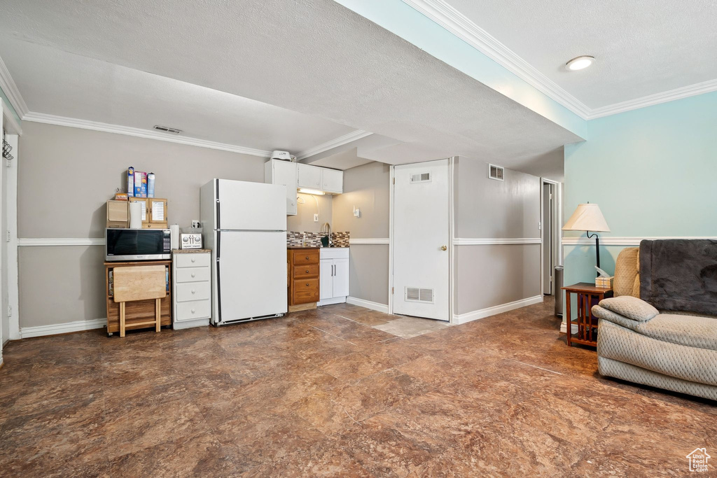 Living area featuring crown molding