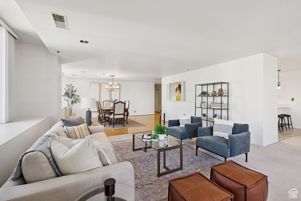 Living room with a chandelier and light colored carpet