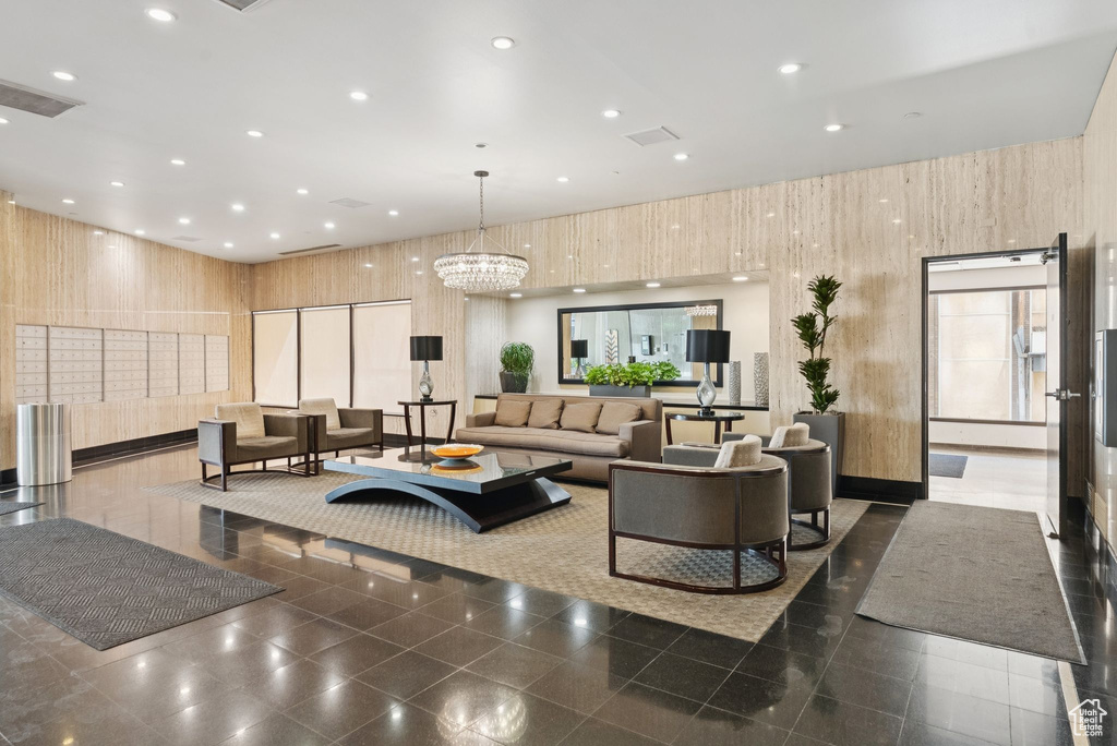 Community lobby featuring recessed lighting, wood walls, and a high ceiling