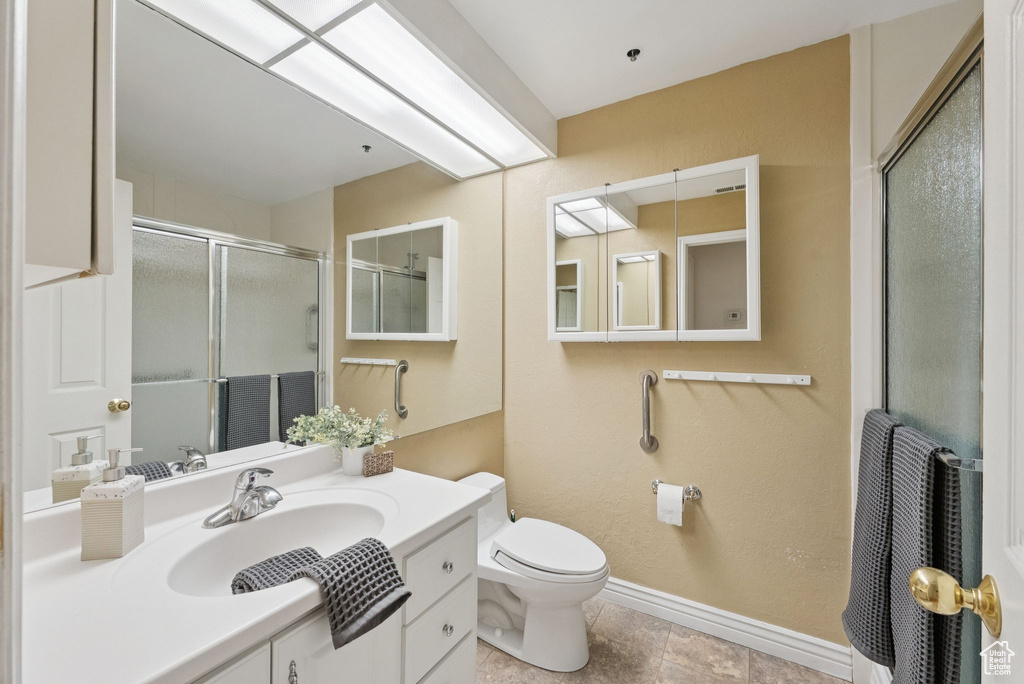 Full bathroom featuring an enclosed shower and vanity