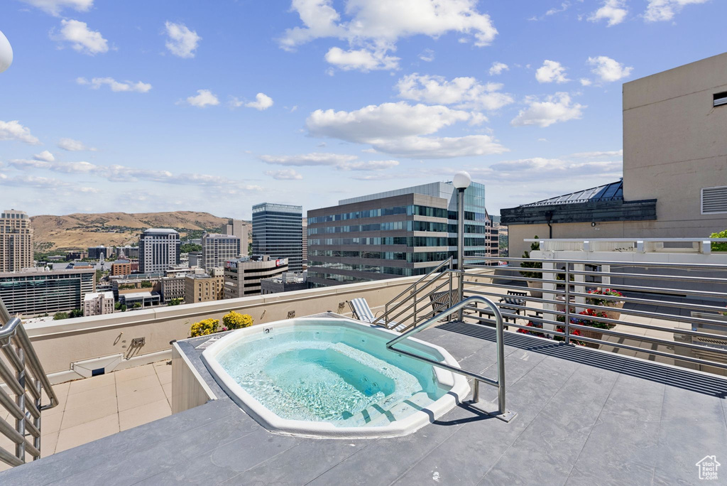 View of swimming pool featuring a hot tub and a view of city