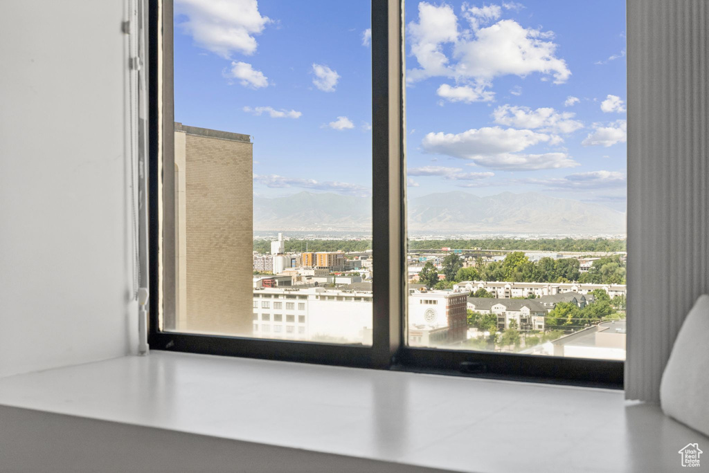 Unfurnished room with healthy amount of natural light and a mountain view