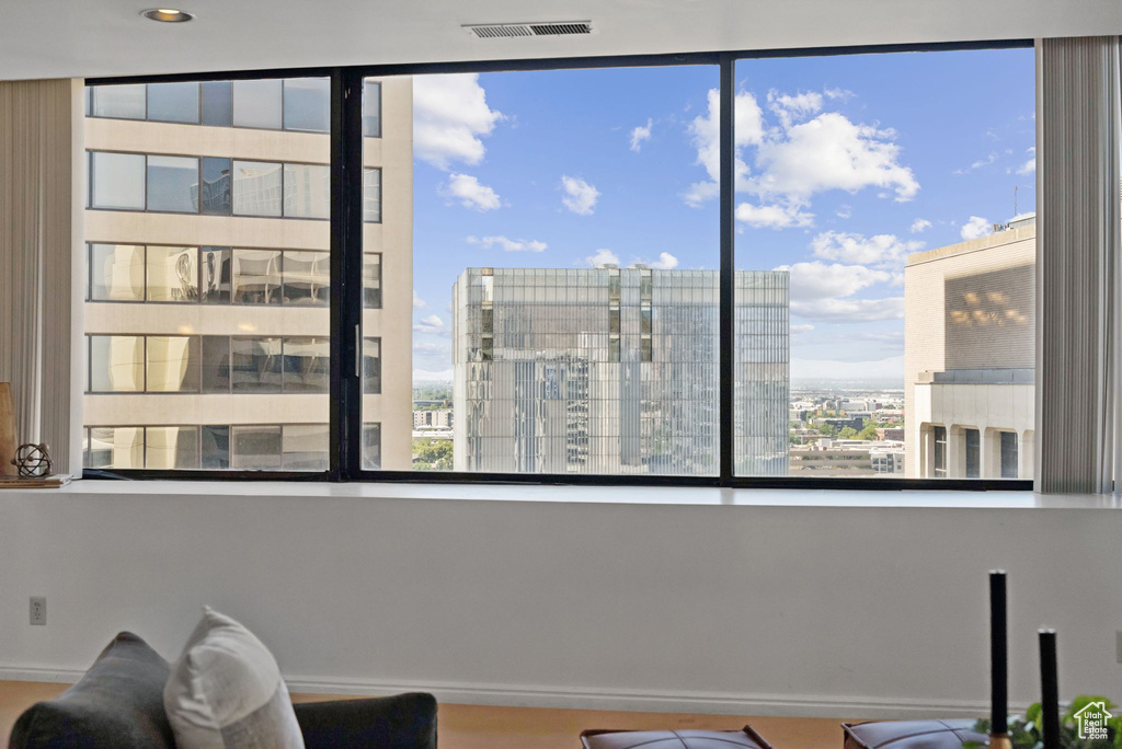 Sitting room with healthy amount of natural light and a city view