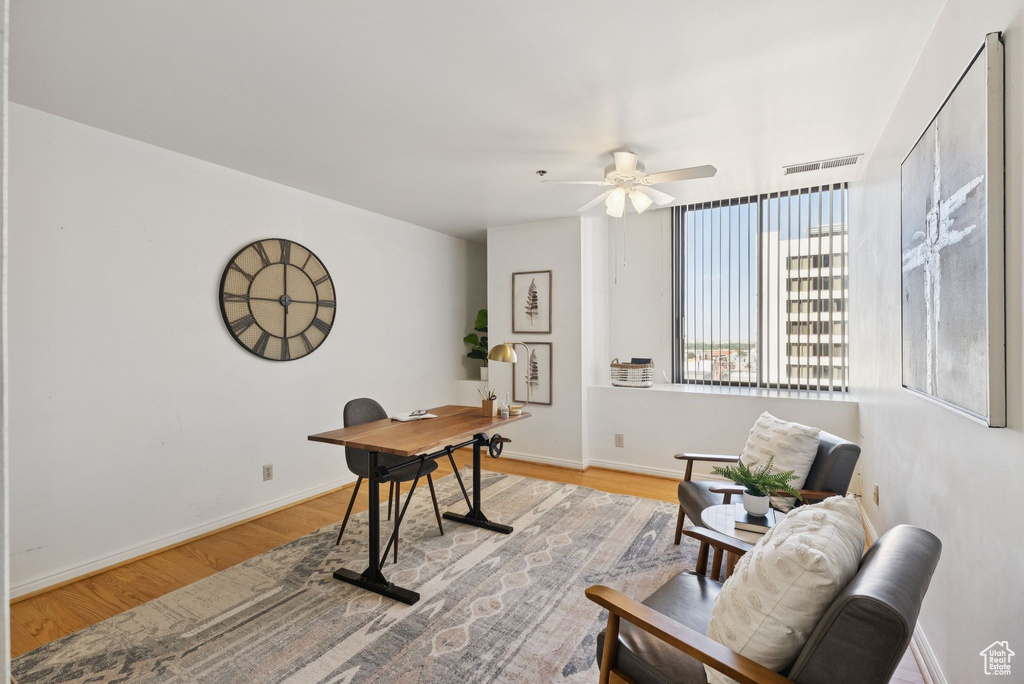 Office area featuring ceiling fan and light wood-style flooring