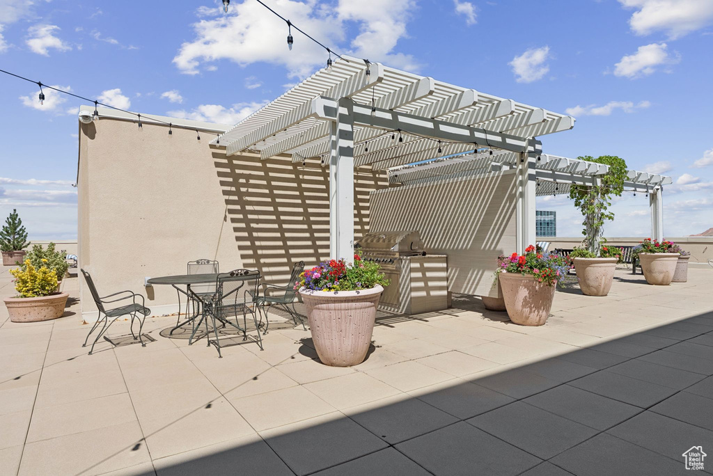 View of patio / terrace featuring a pergola, exterior kitchen, and outdoor dining space