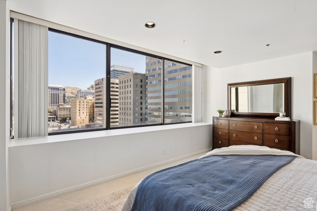 Bedroom featuring multiple windows and a view of city