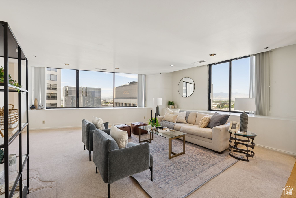 Carpeted living room featuring baseboards