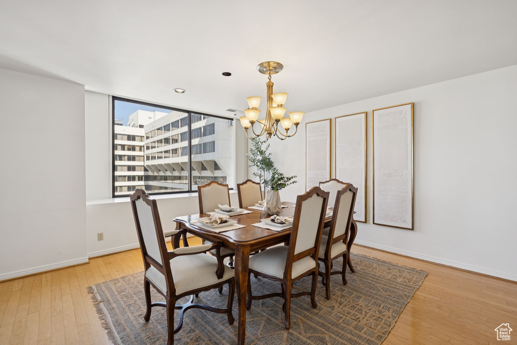 Dining space featuring a chandelier and wood finished floors