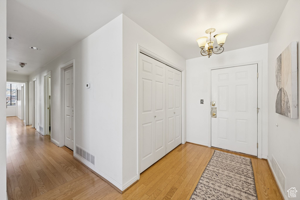 Entryway featuring a chandelier and light wood-type flooring