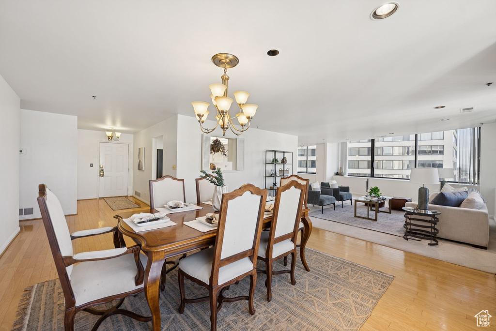 Dining space featuring a chandelier and light wood-style flooring