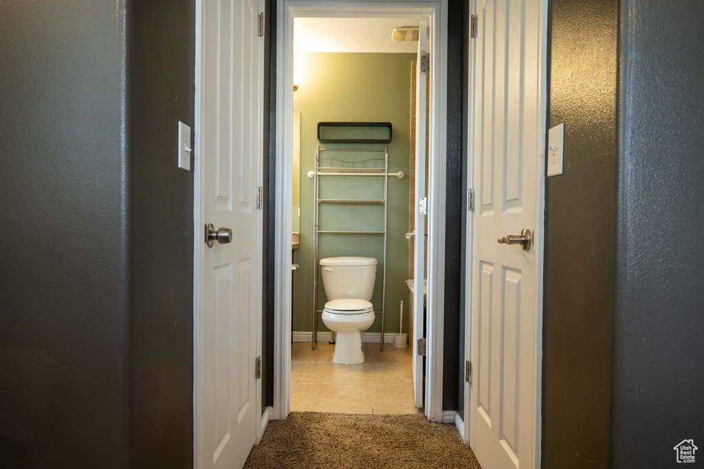 Bathroom with toilet and tile patterned flooring