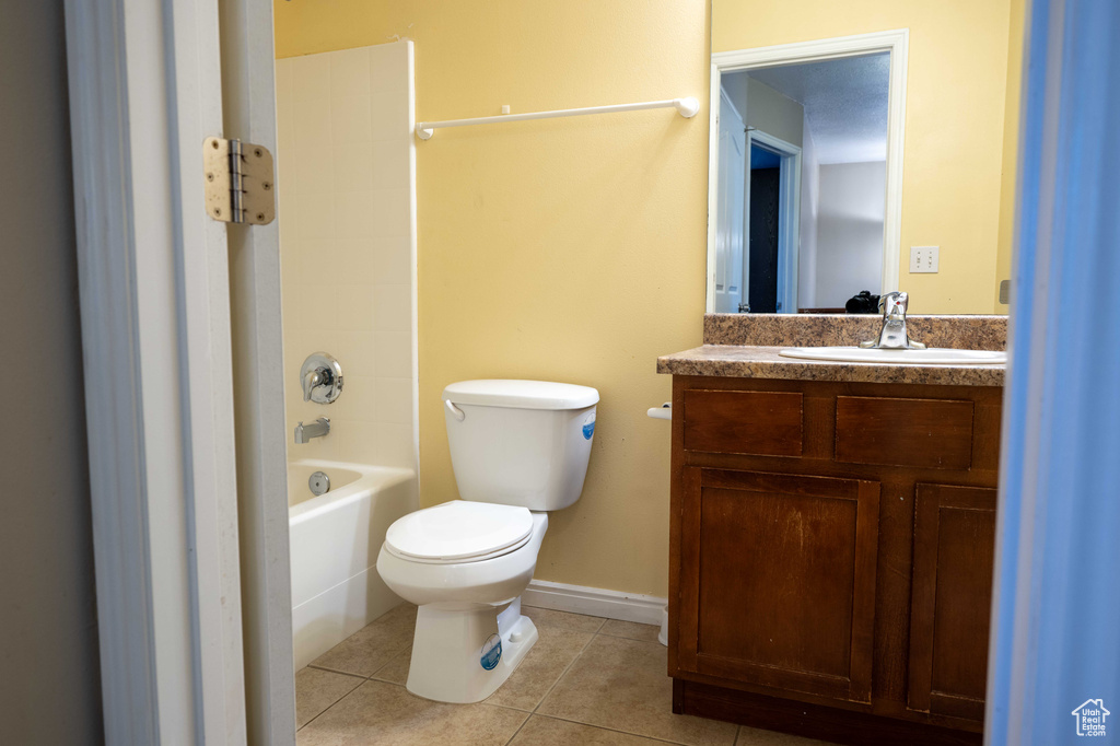 Full bath featuring tile patterned floors, vanity, and bathing tub / shower combination