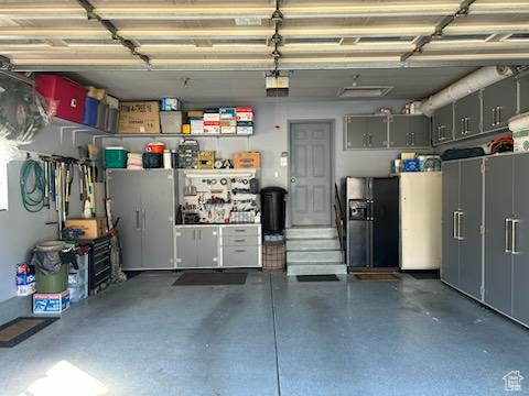 Garage with black refrigerator with ice dispenser