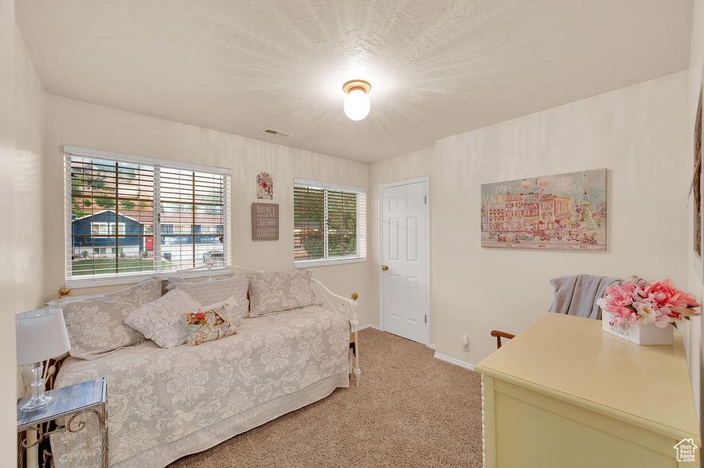 Bedroom featuring light colored carpet and baseboards