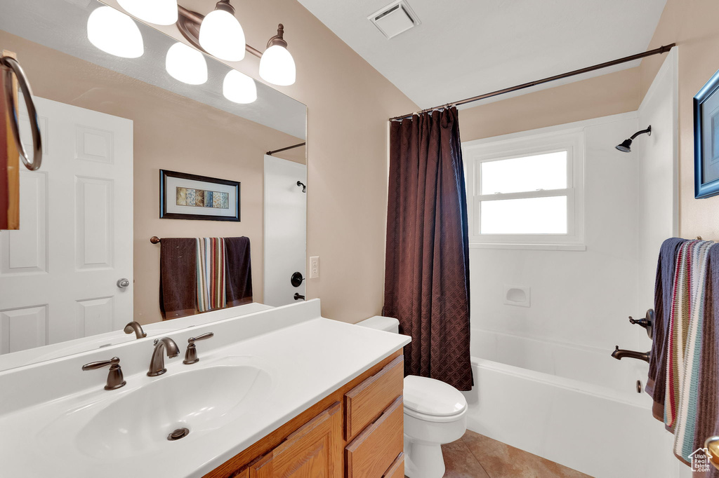 Full bathroom featuring shower / bath combination with curtain, vanity, and tile patterned floors