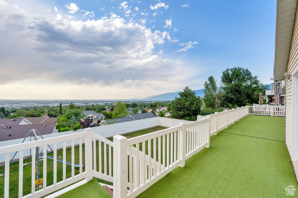 Patio / terrace featuring a mountain view and a lawn