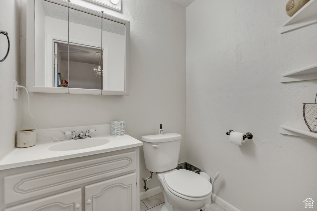 Half bath featuring vanity and toilet