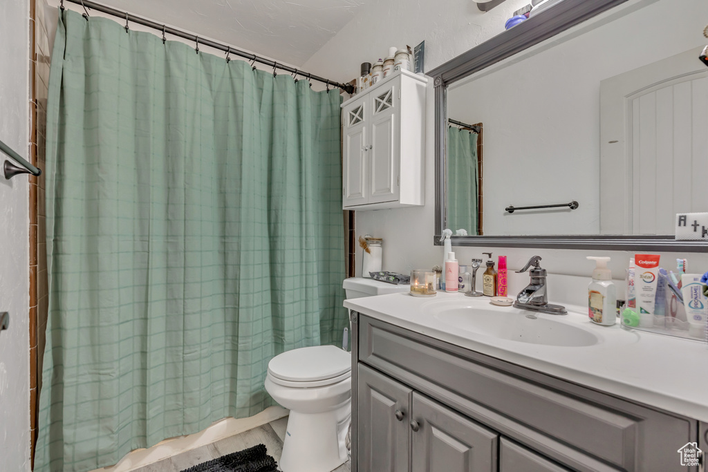 Full bathroom featuring vanity and curtained shower