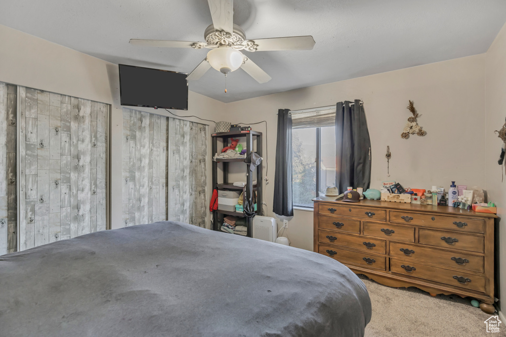 Bedroom featuring a ceiling fan and carpet floors