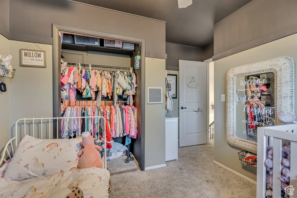 Bedroom featuring carpet flooring and baseboards
