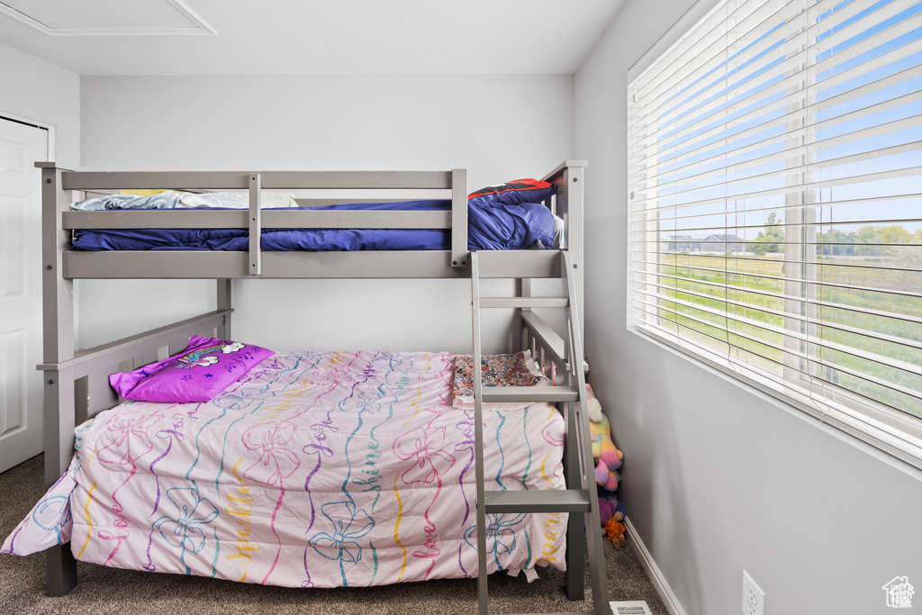 Carpeted bedroom with multiple windows