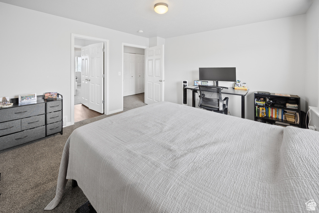 Bedroom with carpet flooring and ensuite bathroom