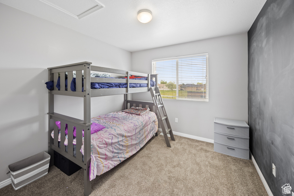 Bedroom with carpet flooring and attic access