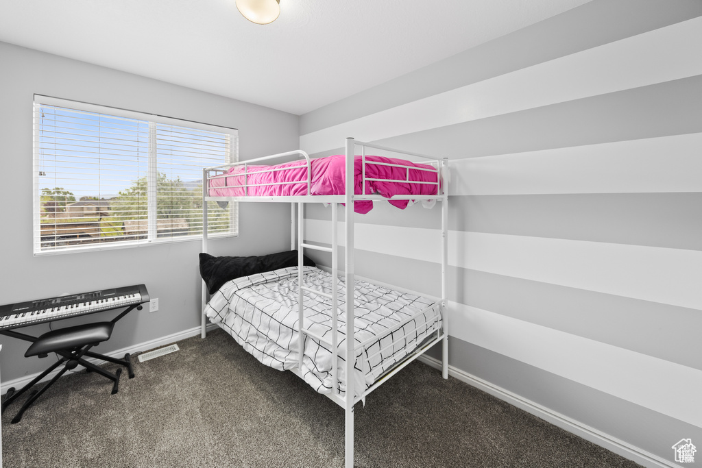 Bedroom with carpet floors and baseboards