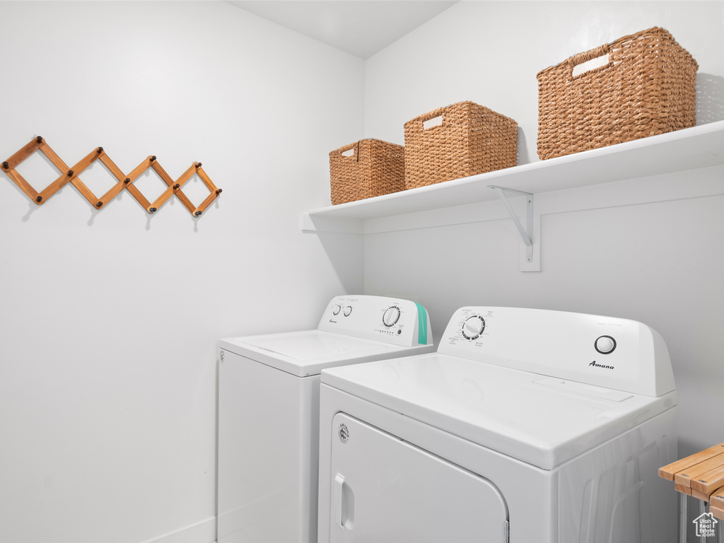 Laundry room with washing machine and clothes dryer