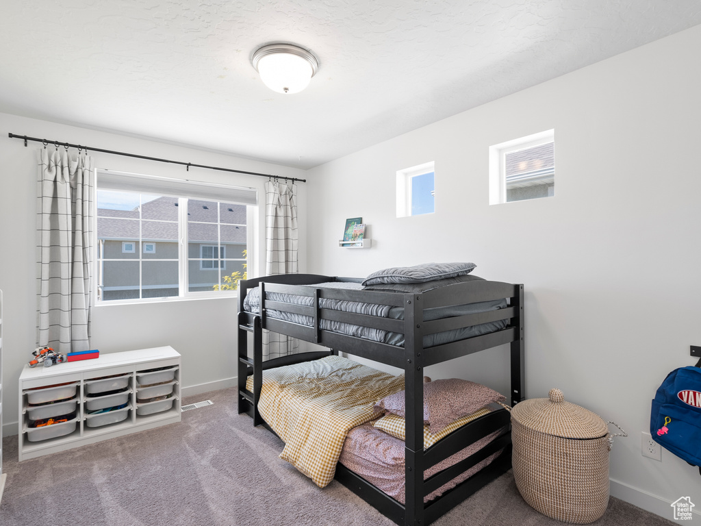 Bedroom with baseboards and carpet flooring