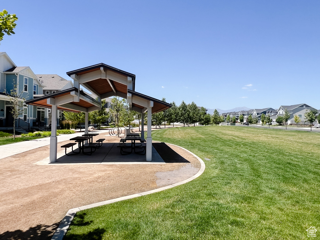 View of property's community with a residential view, a yard, a gazebo, and a mountain view