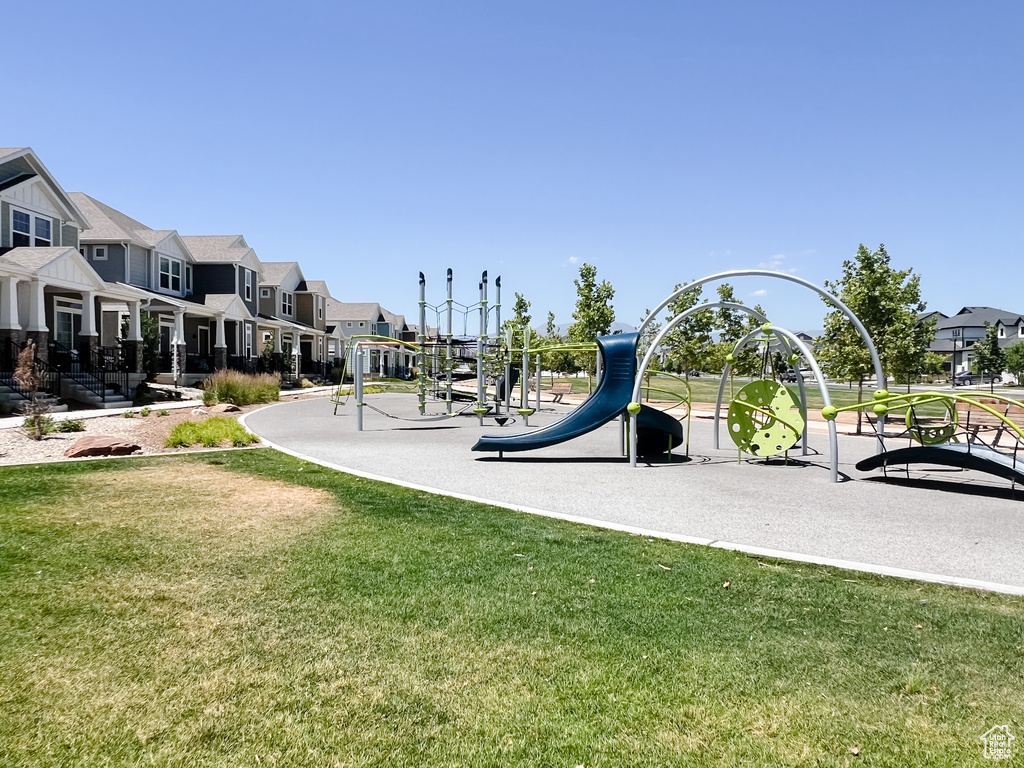 Community jungle gym with a residential view and a yard