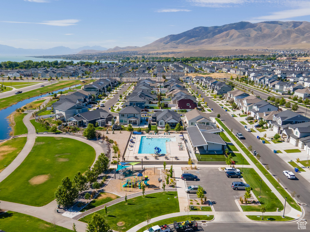 Aerial view of residential area featuring a pool area and a water and mountain view