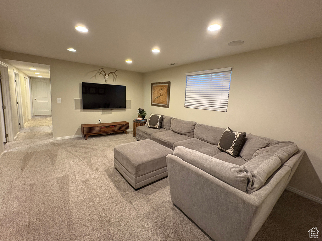Living room with recessed lighting and light carpet