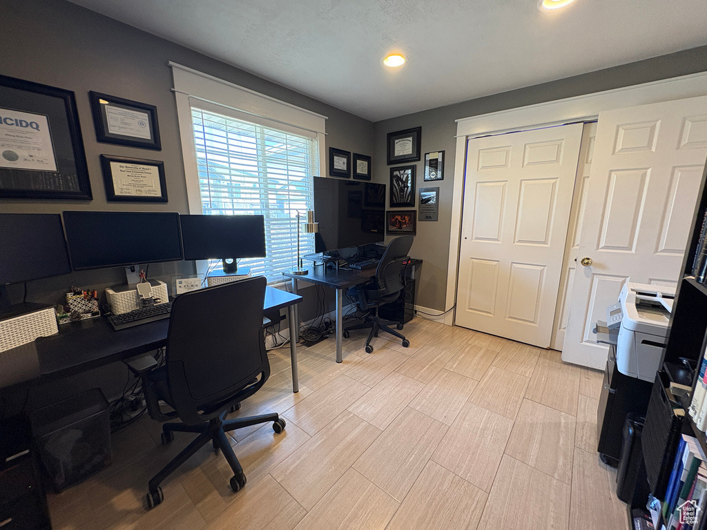 Office with recessed lighting and light wood-style floors