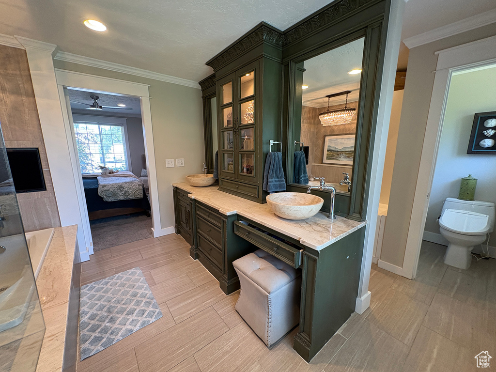 Bathroom featuring ensuite bath, vanity, crown molding, ceiling fan, and recessed lighting