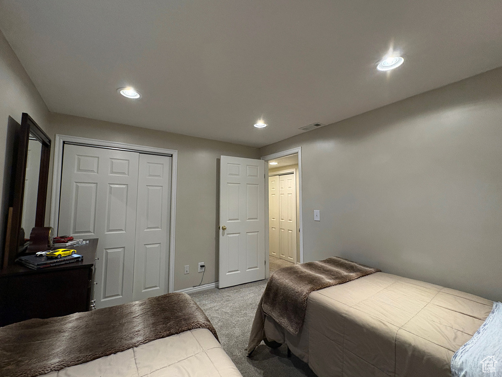 Bedroom featuring carpet, recessed lighting, and a closet