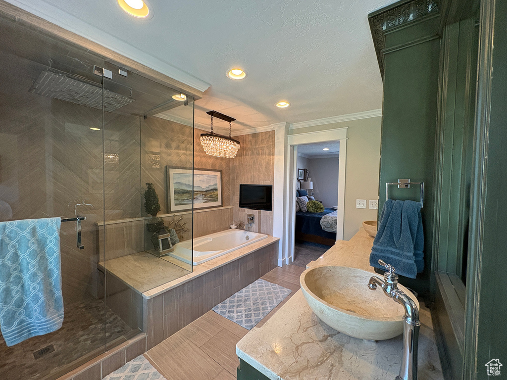 Bathroom featuring crown molding, ensuite bath, a stall shower, a garden tub, and recessed lighting