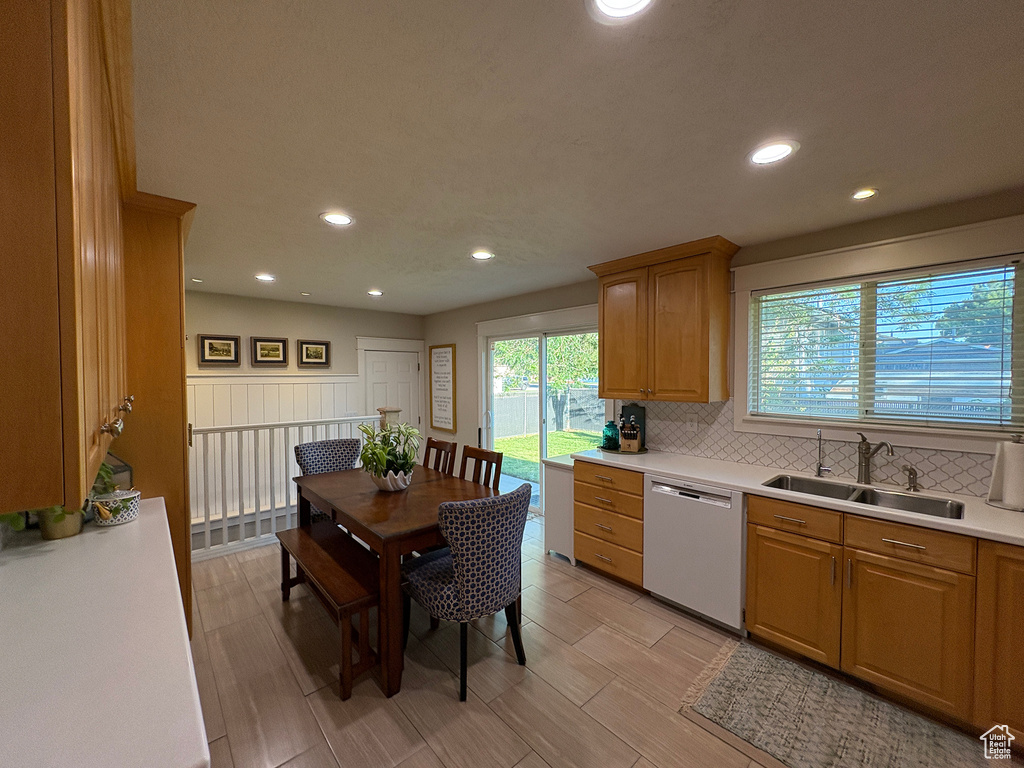 Kitchen with dishwasher, light countertops, plenty of natural light, decorative backsplash, and recessed lighting