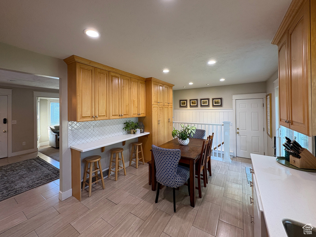 Dining room with wood tiled floors and recessed lighting