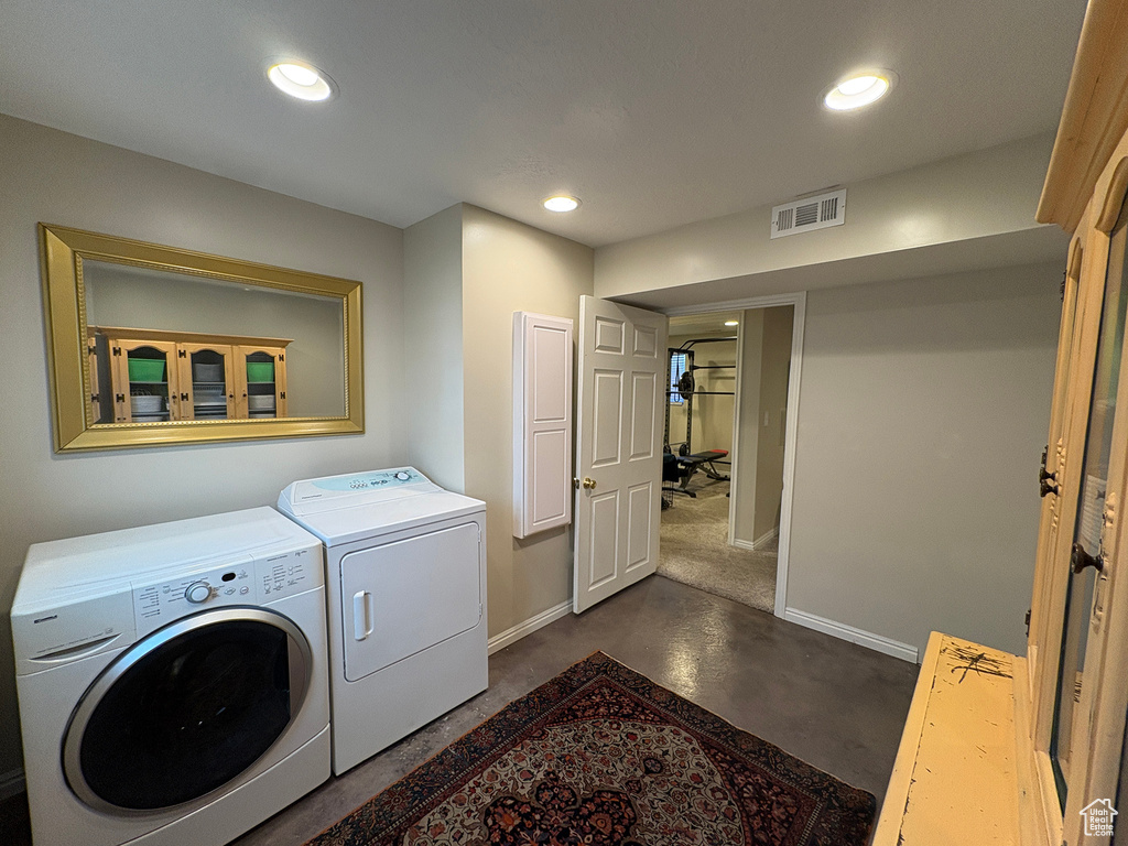 Washroom with separate washer and dryer and recessed lighting