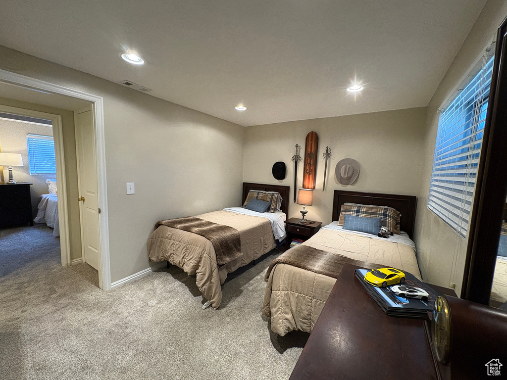 Carpeted bedroom with baseboards and recessed lighting