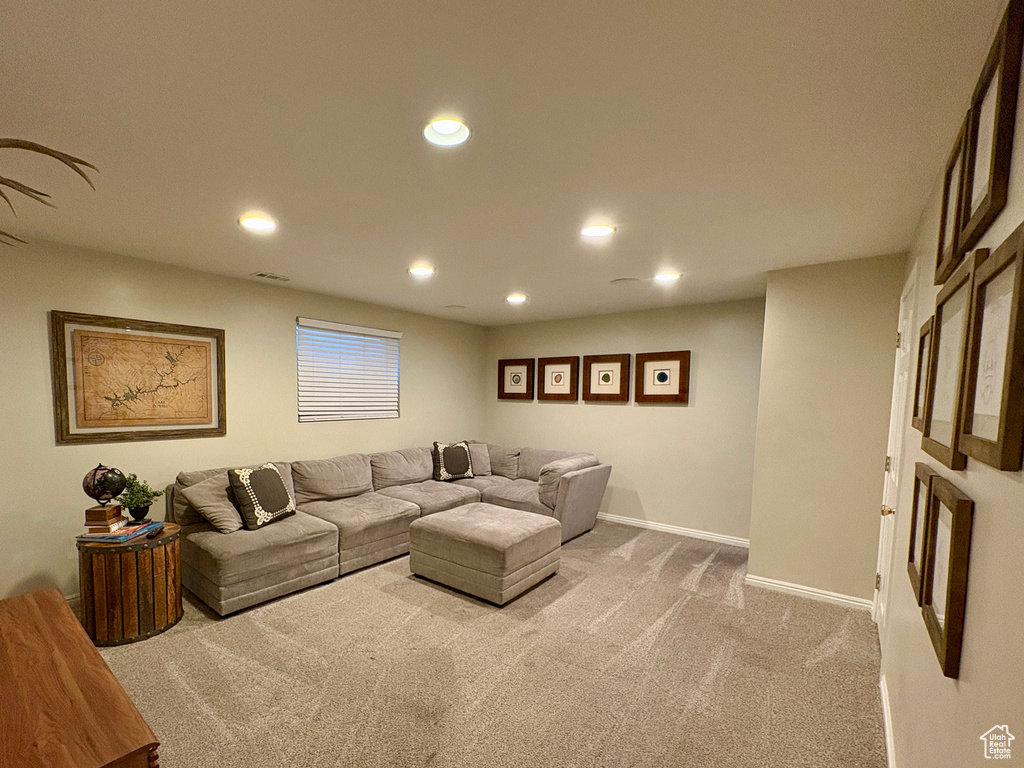 Carpeted living room featuring recessed lighting and baseboards