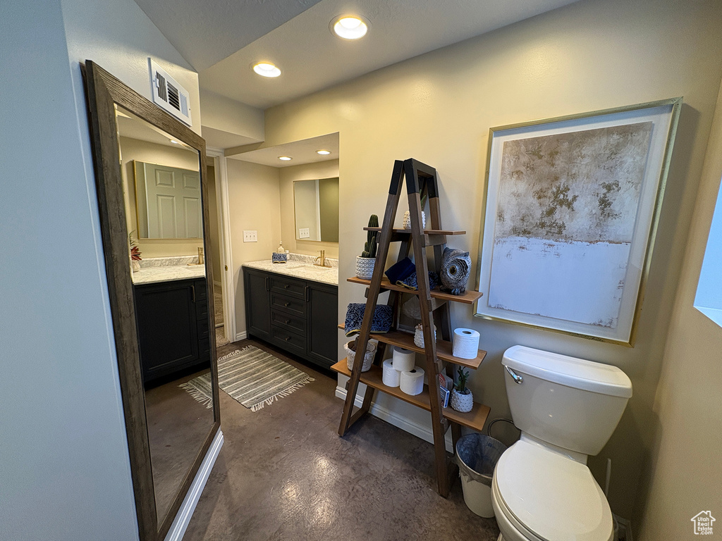 Full bathroom featuring concrete flooring, vanity, and recessed lighting
