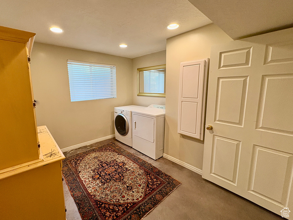 Washroom featuring washing machine and dryer and recessed lighting