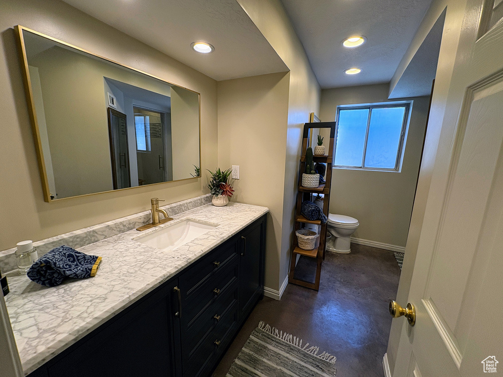 Bathroom featuring vanity and recessed lighting