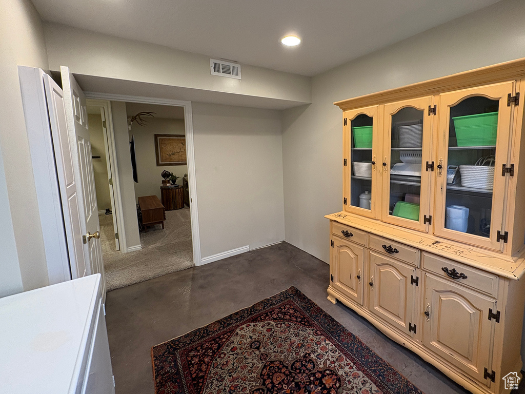 Hallway featuring recessed lighting and concrete flooring