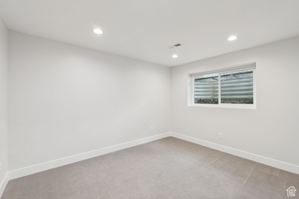 Spare room with light colored carpet and recessed lighting