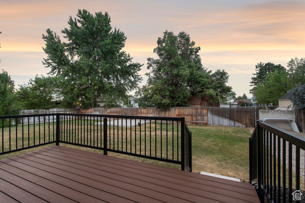 Wooden deck featuring a fenced backyard